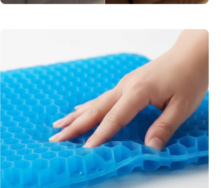 A hand pressing into the gel grid cushion